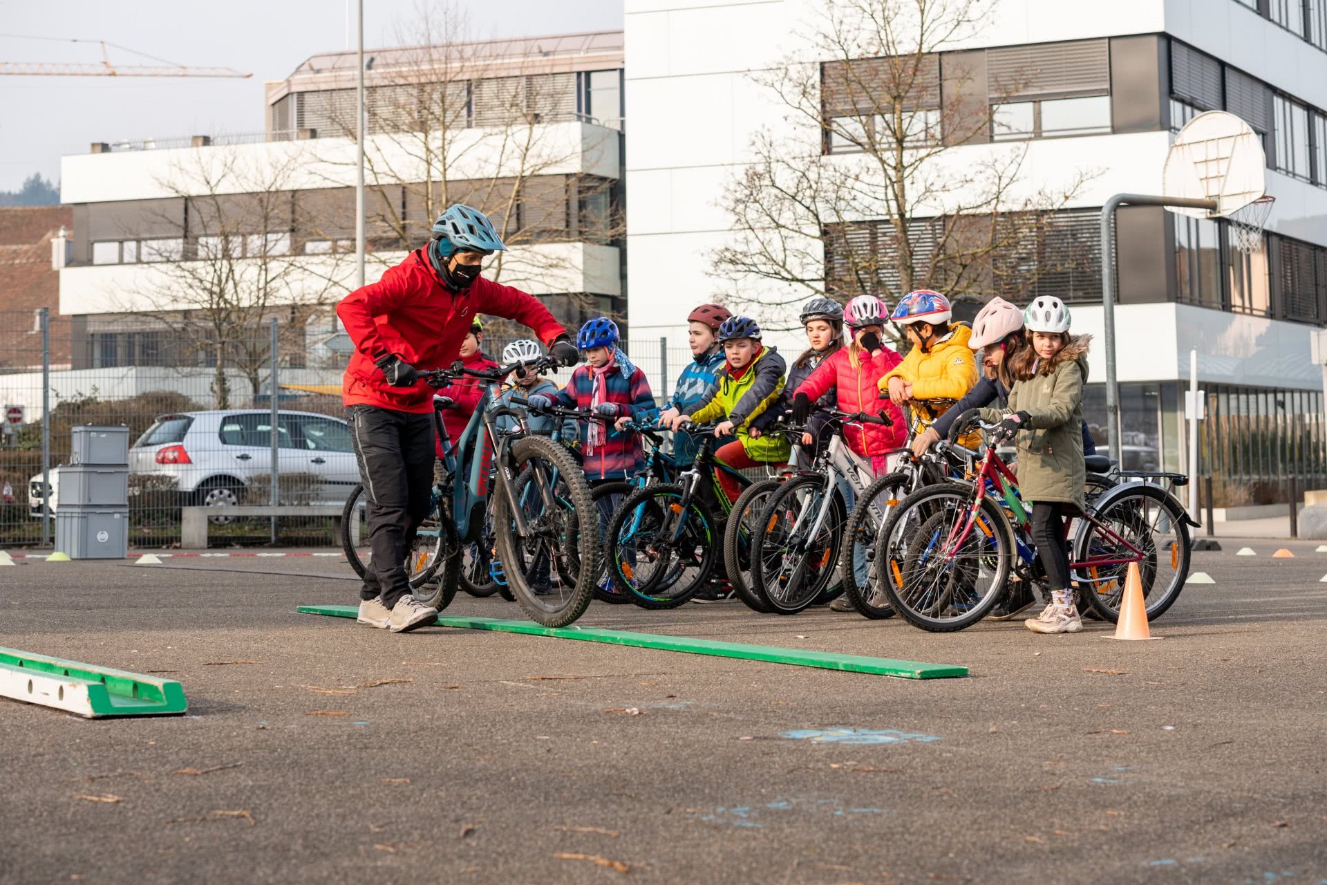 Foto simbolica: Un insegnante mentre insegna de ragazzi con la bici