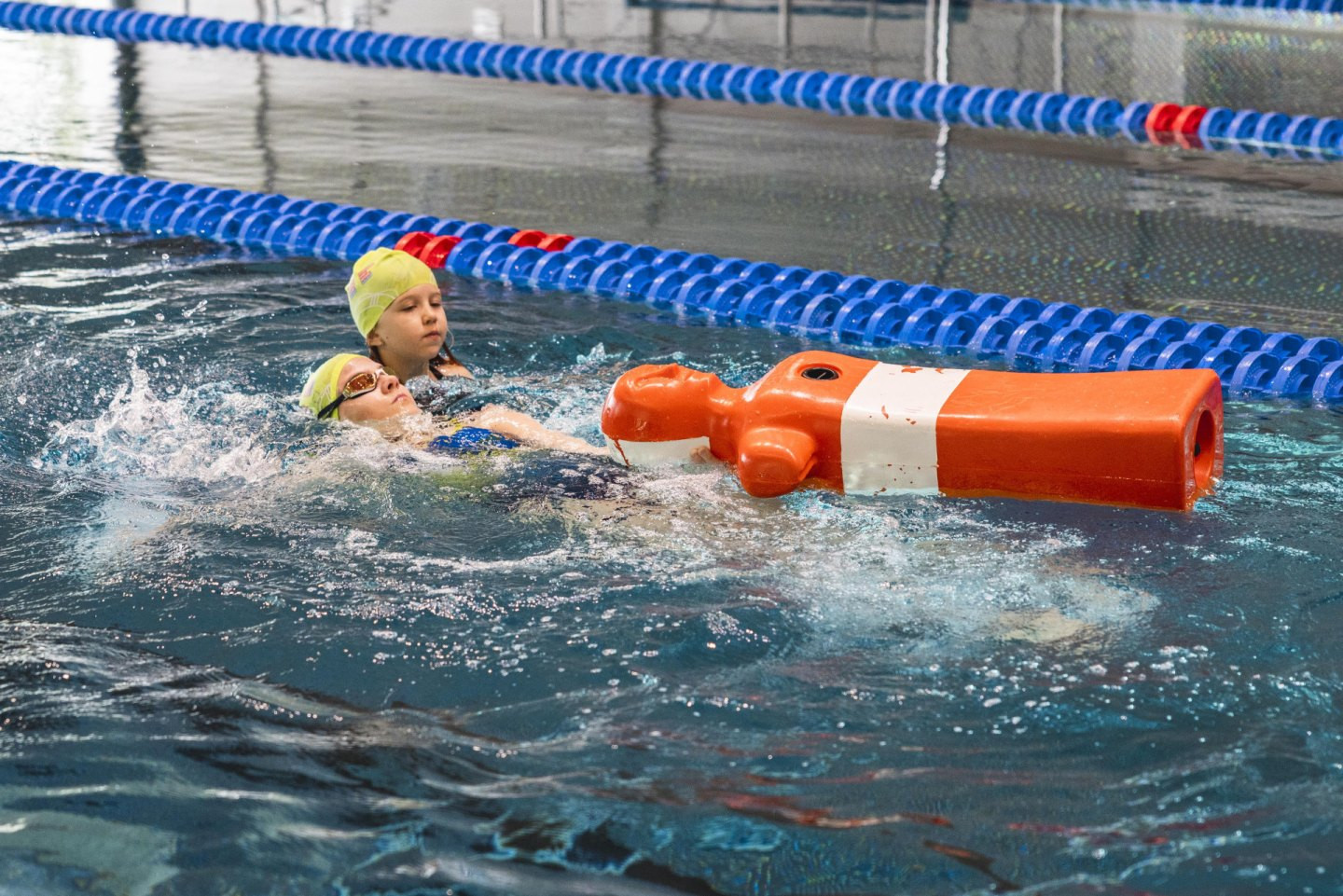 Die Kinder und Jugendlichen trainieren die effiziente Übergabe des Puppenschwimmens.