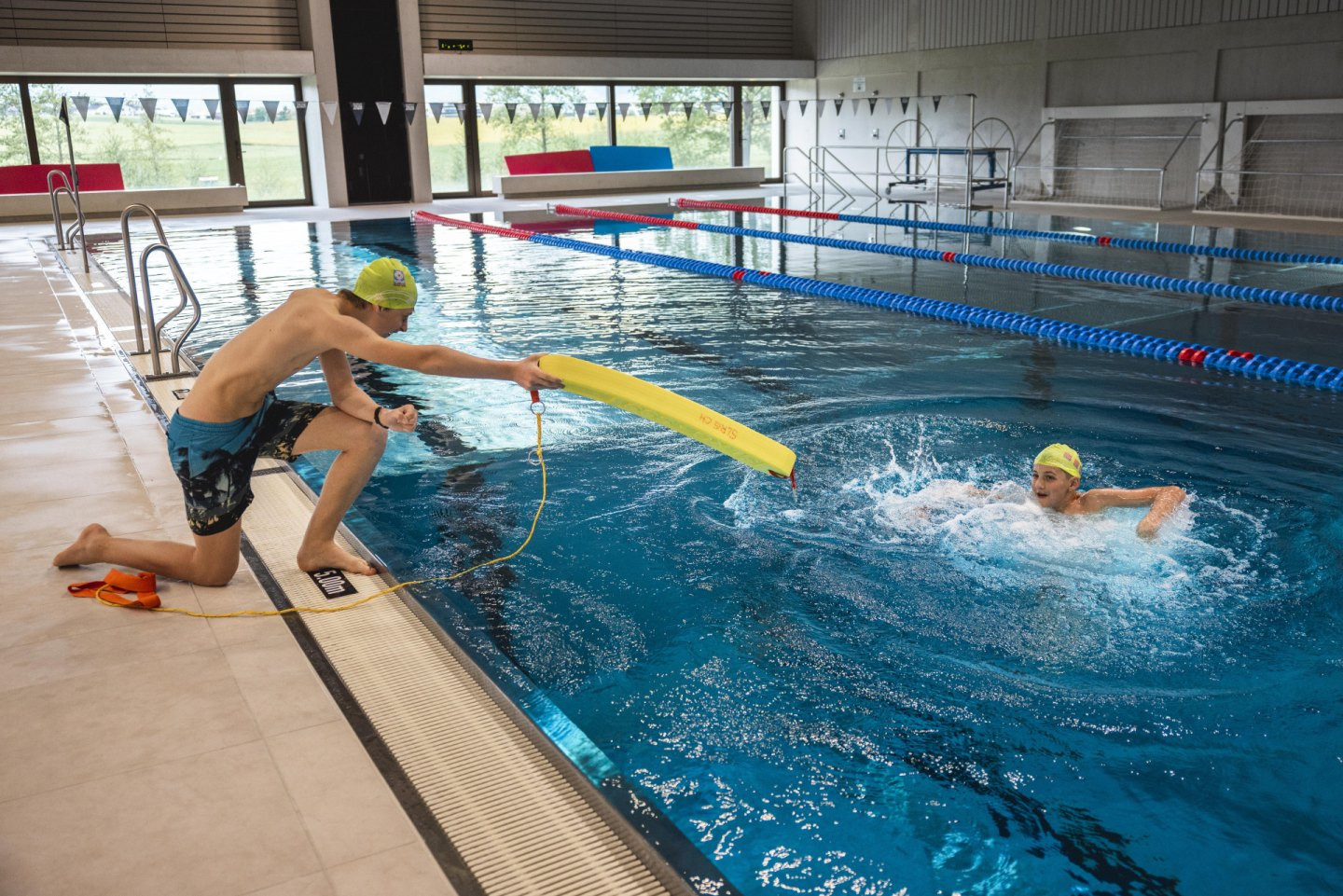 Die Kinder und Jugendlichen führen eine simulierte Notfallübung* durch, indem sie verschiedene Fälle von Notfallsituationen (z. B. ein bewusstlos im Wasser treibendes Kind) vorbereiten, das Rettungsmaterial bereitlegen und die Fälle durchspielen.