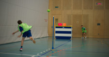 Un jeune lance un ballon de street handball en direction d'une cible.