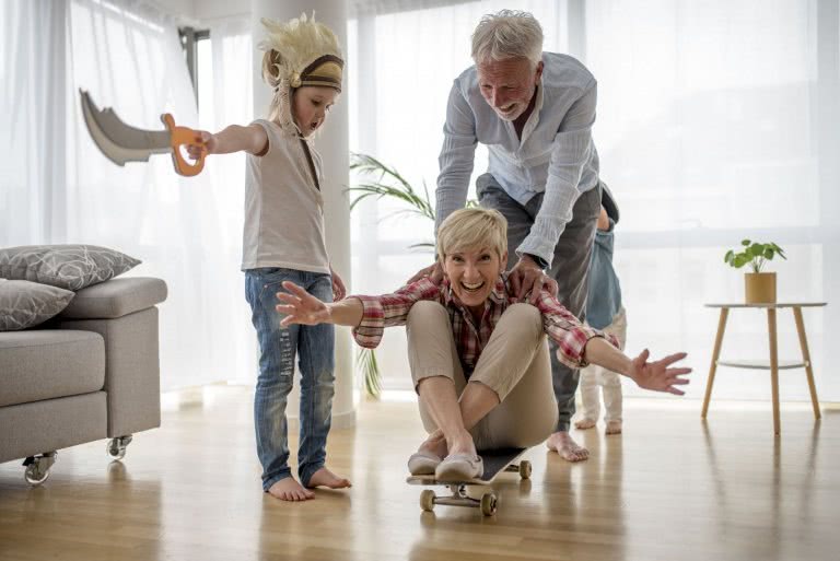Grands-parents jouant avec leur enfant à la maison